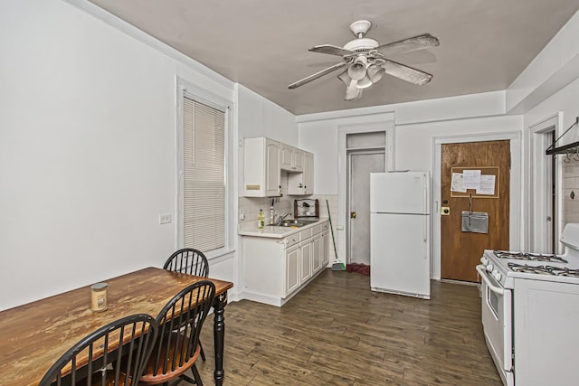 dining area with dark hardwood / wood-style flooring, ceiling fan, and sink