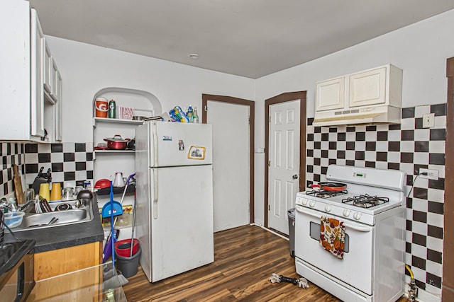 kitchen with dark hardwood / wood-style flooring, decorative backsplash, sink, and white appliances