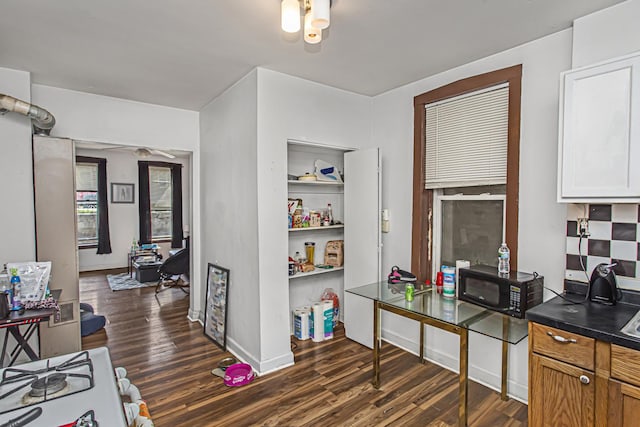 kitchen with white cabinets, dark hardwood / wood-style floors, and white range oven