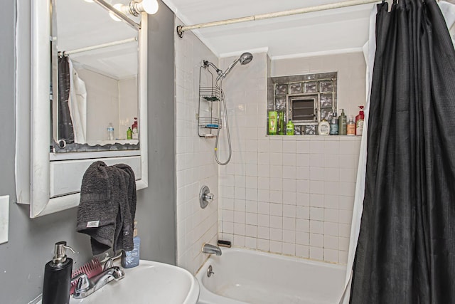 bathroom with shower / bath combination with curtain and sink