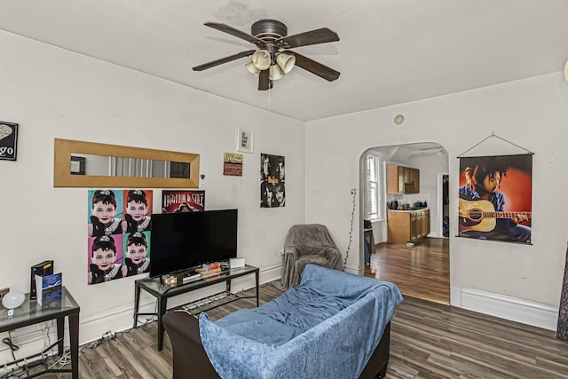 living room with wood-type flooring and ceiling fan