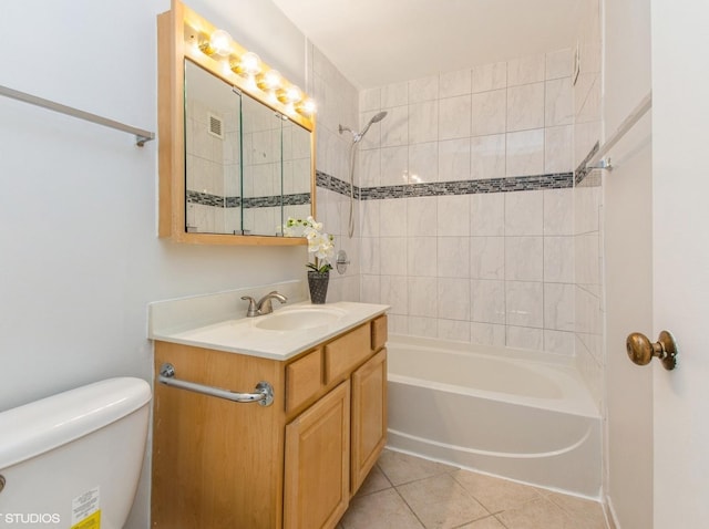 full bathroom with tile patterned flooring, tiled shower / bath combo, toilet, and vanity