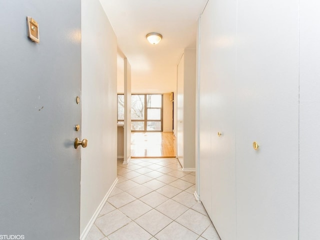 corridor with light tile patterned floors