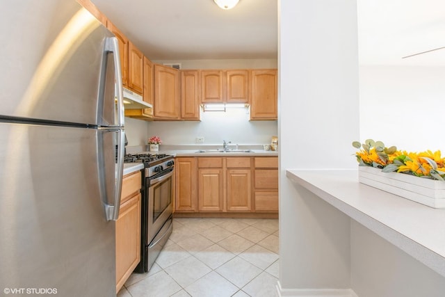 kitchen with sink, light tile patterned floors, and stainless steel appliances