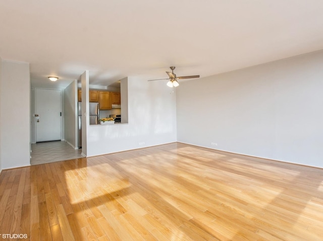 unfurnished living room featuring light hardwood / wood-style flooring and ceiling fan