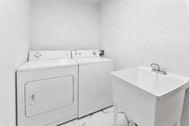 laundry room with washing machine and clothes dryer and sink