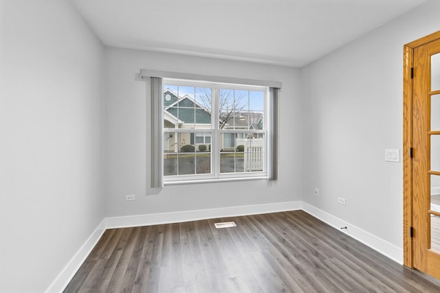 unfurnished room featuring dark wood-type flooring