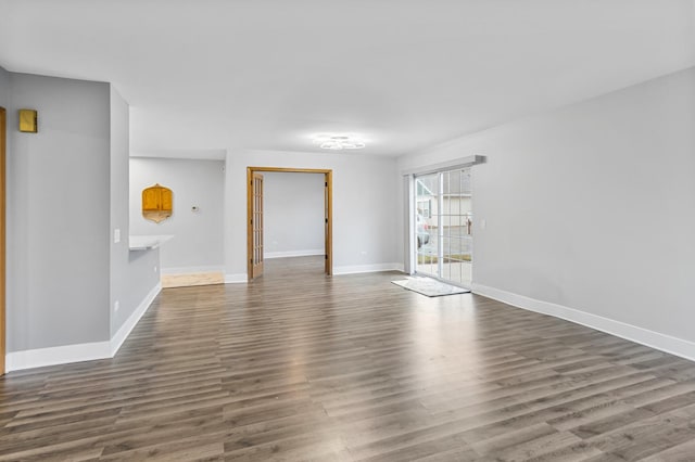 spare room featuring dark wood-type flooring