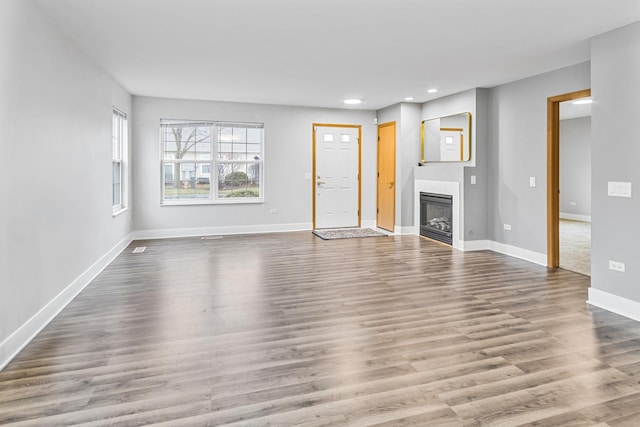 unfurnished living room featuring hardwood / wood-style flooring