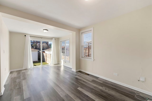 spare room featuring dark hardwood / wood-style floors