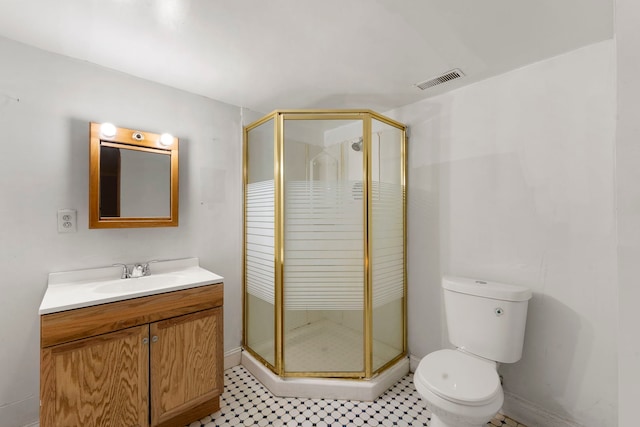 bathroom with vanity, a shower with shower door, and toilet