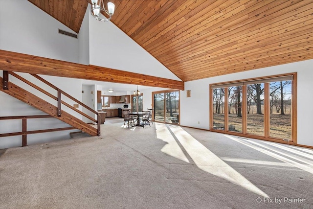 unfurnished living room featuring carpet flooring, an inviting chandelier, high vaulted ceiling, and wooden ceiling