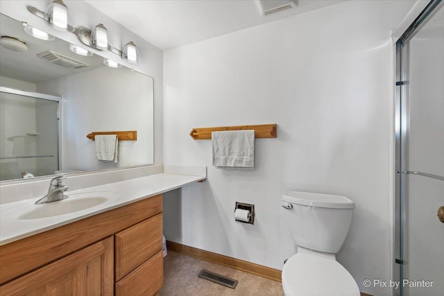 bathroom featuring vanity, toilet, and an enclosed shower