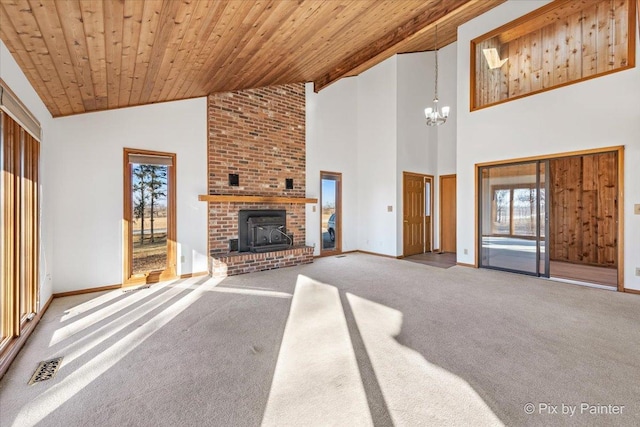 unfurnished living room with carpet flooring, a fireplace, high vaulted ceiling, and wood ceiling