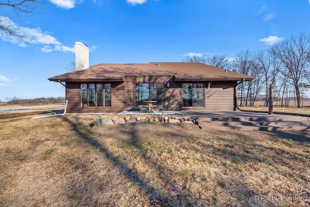 rear view of house with a lawn and a patio area