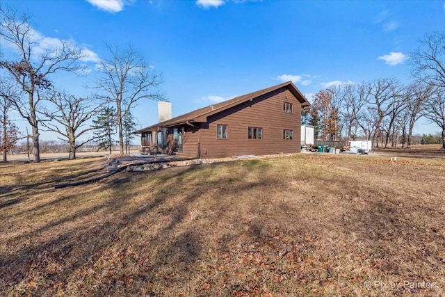 view of side of property with a lawn