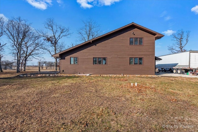 view of side of home featuring a yard