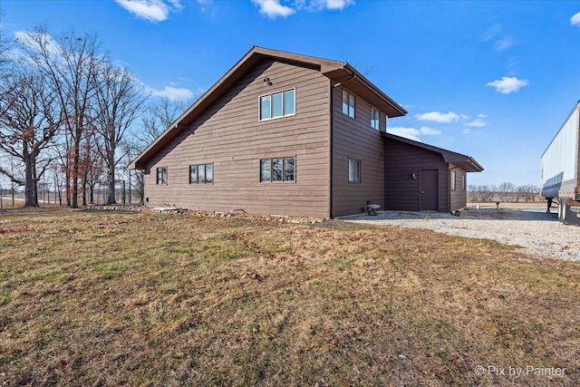 view of side of home with a lawn