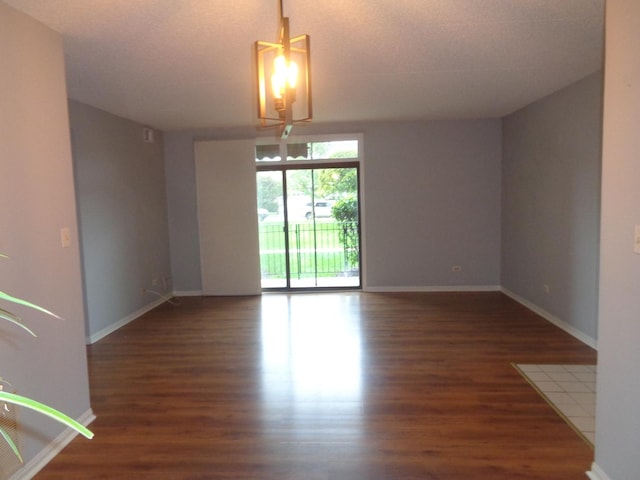 spare room with dark wood-type flooring