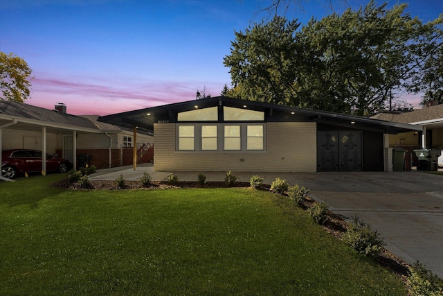 view of front of house with a carport and a yard