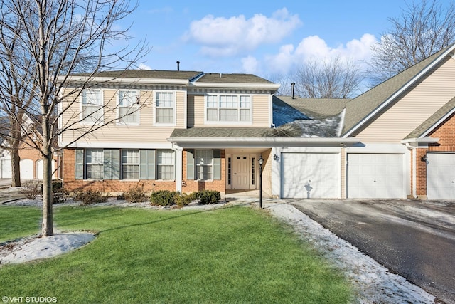 front facade with a garage and a front yard