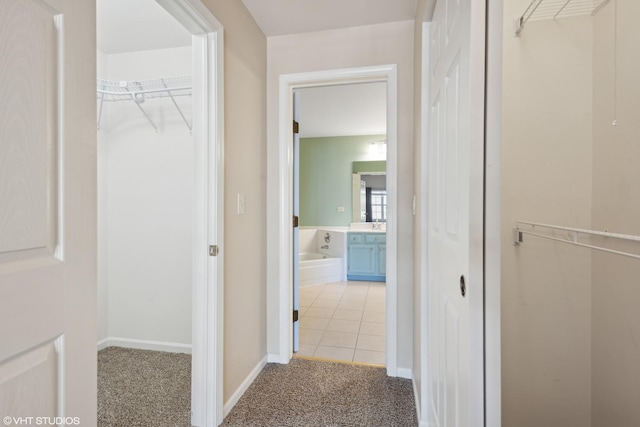 hallway with light colored carpet