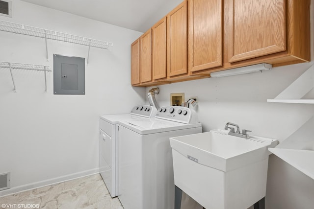 laundry room with washer and clothes dryer, cabinets, sink, and electric panel