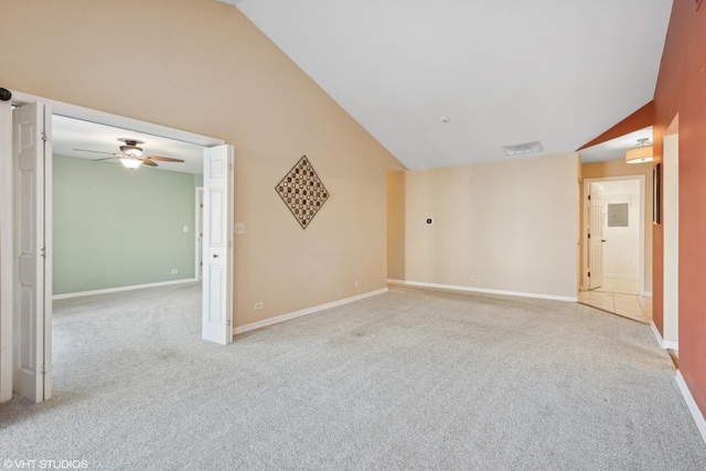 carpeted spare room with ceiling fan and lofted ceiling