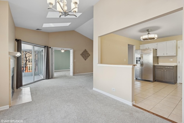 kitchen featuring decorative light fixtures, white cabinetry, stainless steel fridge with ice dispenser, and light carpet