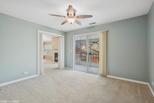 carpeted spare room with ceiling fan