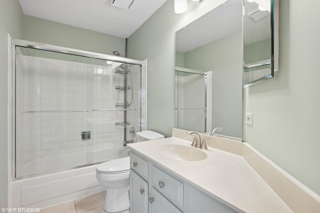 full bathroom with tile patterned flooring, vanity, toilet, and enclosed tub / shower combo