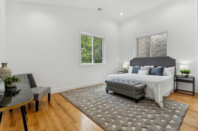 bedroom featuring hardwood / wood-style floors and vaulted ceiling