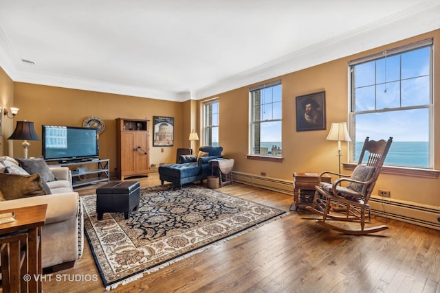 living room featuring hardwood / wood-style flooring, a water view, ornamental molding, and a baseboard radiator