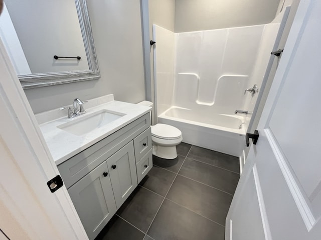 full bathroom with toilet, vanity, tile patterned floors, and tub / shower combination