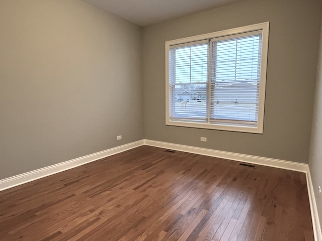 empty room featuring dark hardwood / wood-style flooring