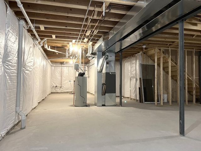 basement featuring heating unit and water heater