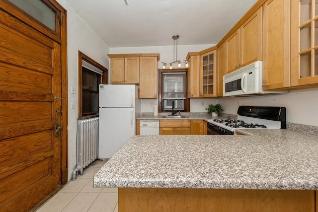 kitchen with kitchen peninsula, sink, decorative light fixtures, and white appliances