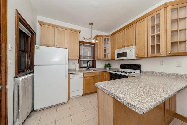 kitchen featuring pendant lighting, white appliances, radiator, sink, and kitchen peninsula