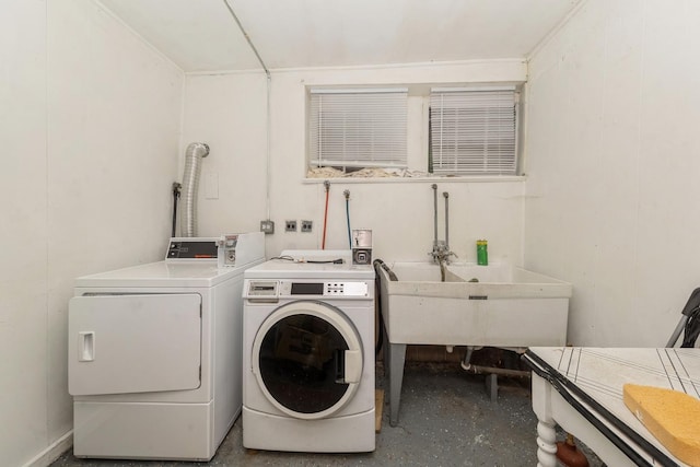 clothes washing area featuring washer and clothes dryer and sink