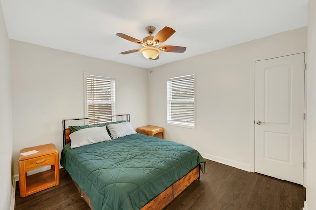 bedroom with ceiling fan and dark hardwood / wood-style flooring