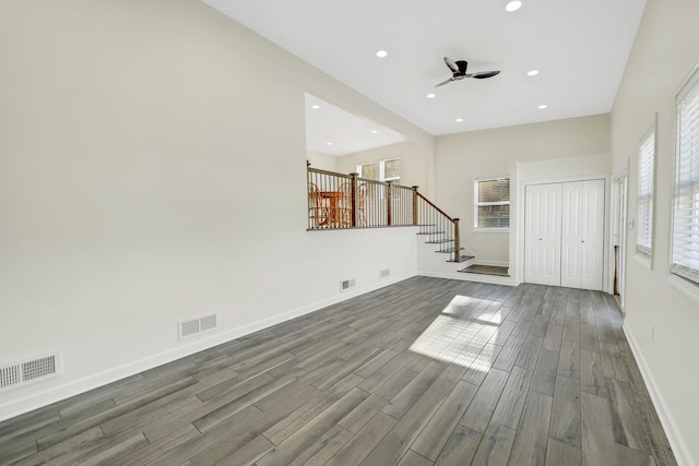 unfurnished living room with ceiling fan and wood-type flooring