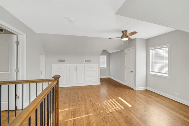 additional living space featuring ceiling fan, a healthy amount of sunlight, and vaulted ceiling