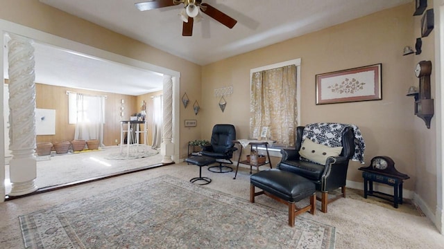 sitting room with ceiling fan and carpet