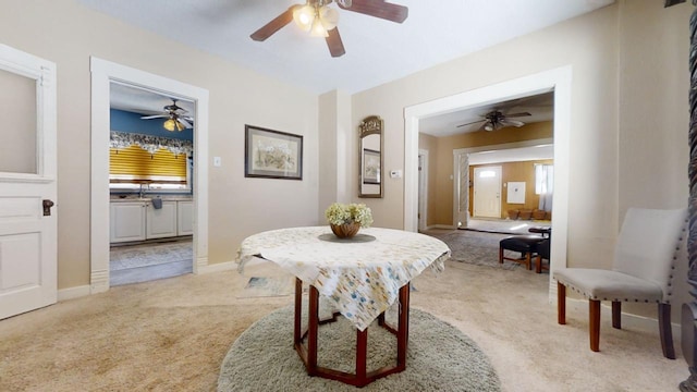 dining space featuring light colored carpet and sink