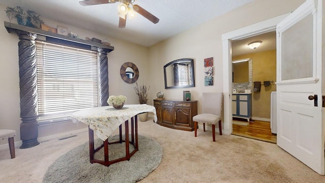 carpeted office featuring ceiling fan