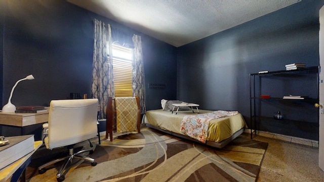 bedroom with a textured ceiling and carpet flooring