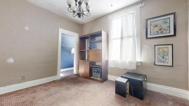 carpeted home office with a notable chandelier and plenty of natural light