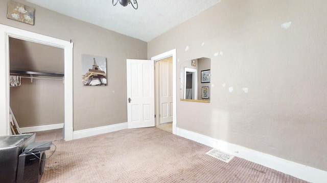 interior space with lofted ceiling, a textured ceiling, and carpet floors