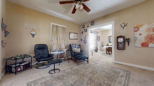 sitting room with carpet flooring and ceiling fan