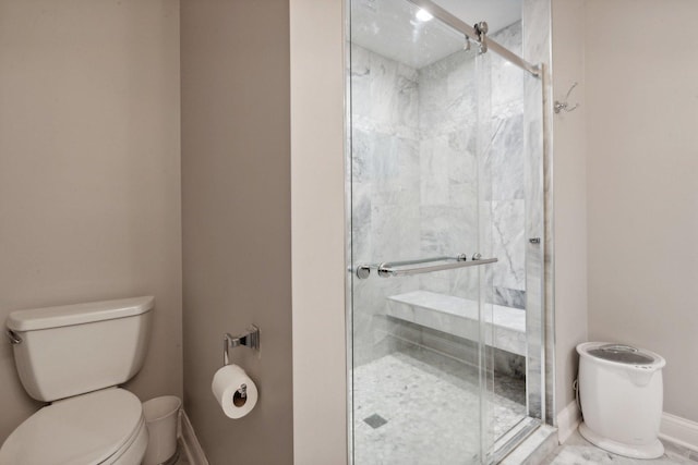 bathroom with a shower with door and toilet